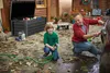 A father and son are washing a car in a yard with fallen leaves. Produktbild-Vorschau