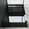 A modern black acrylic shower tray with a silver drain grate, set in a bathroom with concrete-like flooring and walls. Produktbild-Vorschau