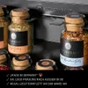 A close-up shot of spice jars on a shelf, with text describing product features. Produktbild-Vorschau