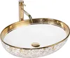 A close-up studio shot of a decorative washbasin with a gold faucet. Produktbild-Vorschau