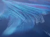 Close-up of ice crystals forming on a blue surface. Produktbild-Vorschau