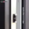 A close-up view of a door lock mechanism, specifically a strike plate, mounted on a door frame. Produktbild-Vorschau