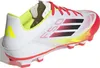 A side view of a white Adidas F50 Club FG/MG soccer cleat with red laces and accents. Produktbild-Vorschau