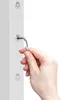 A hand is using an Allen wrench to tighten a screw on a white metal pole, likely part of a pergola or gazebo assembly. Produktbild-Vorschau