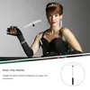 A woman in a black dress and gloves holds a shot glass and a poker chip rake. Produktbild-Vorschau