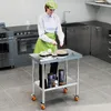 A person in a kitchen setting is arranging plates on a stainless steel table. Produktbild-Vorschau
