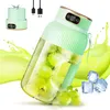 A portable blender filled with grapes and ice, with a splash of green juice behind it. Produktbild-Vorschau