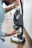 A person is shown using a BISSELL CrossWave vacuum cleaner on a wooden floor. Voir les images du produit