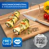 Food preparation scene on a wooden cutting board with zucchini rolls, a knife, and vegetables. Produktbild-Vorschau