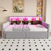 A gray upholstered daybed with built-in shelving and LED lighting, set up in a bedroom with a patterned rug and artwork on the wall. Náhled obrázku produktu