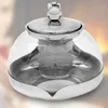 A glass teapot with a metal lid and infuser is shown against a blurred background. Produktbild-Vorschau