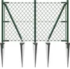 A chain-link fence section with green metal posts and supports, anchored by pointed metal ground sleeves. Náhled obrázku produktu