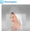 A woman with a towel on her head winks at the camera, with a steamy, water-droplet-covered background. Produktbild-Vorschau