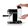 A black and silver espresso machine with a clear water tank being attached by a person's hands. Produktbild-Vorschau