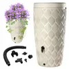 A rain barrel with a planter on top, and accessories laid out below, all on a white background. Produktbild-Vorschau