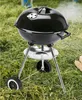 A black charcoal kettle grill sits on grass. Náhľad obrázku produktu