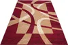 A rectangular rug with a modern abstract design featuring curved lines and geometric shapes in red, beige, and cream colors, displayed on a white background. Náhled obrázku produktu
