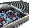 A close-up view of glowing charcoal inside a grill. Produktbild-Vorschau
