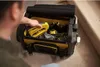 A person is reaching into a tool bag to grab a yellow stapler. Náhled obrázku produktu
