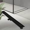 A black linear shower drain is shown on a tiled floor in a modern bathroom setting. Náhľad obrázku produktu