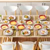 A table set with multiple plates of food and cutlery, arranged for a meal. Produktbild-Vorschau
