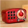 A close-up shot of a red retro-style radio sitting on a wooden surface. Produktbild-Vorschau
