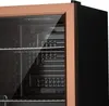 Close-up view of the interior of a mini-refrigerator with glass door and metallic shelves. Náhľad obrázku produktu