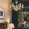 A bedroom scene with a chandelier and lamps. Anteprima dell’immagine prodotto