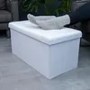 Feet in socks resting on a white storage ottoman in a living room setting. Podgląd zdjęcia produktu