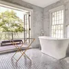 A modern bathroom with a freestanding bathtub and French doors opening to a balcony. Podgląd zdjęcia produktu