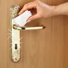 A hand is cleaning a door handle with a wipe. Produktbild-Vorschau