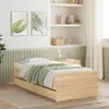 A bedroom scene with a wooden bed frame and green bedding. Voir les images du produit