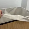 A close-up of the top of a laundry basket, showing the fabric lining and the bamboo exterior. Produktbild-Vorschau