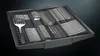 A close-up view of a dishwasher cutlery basket filled with silverware and a spatula. Anteprima dell’immagine prodotto