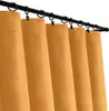 A close-up view of several yellow curtains hanging from a black curtain rod. Náhled obrázku produktu