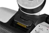Close-up view of a part of a Tineco IFloor 3 Plus wet dry vacuum cleaner, showing a black latch with a small icon and a yellow sticker with text. Podgląd zdjęcia produktu