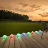Solar lights on a wooden deck at sunset. Produktbild-Vorschau
