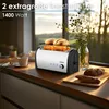 A toaster with bread in it, placed on a kitchen counter with a window in the background. Produktbild-Vorschau