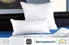 Two white pillows are displayed on a blue surface, with a dark headboard in the background. Produktbild-Vorschau