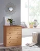A wooden chest of drawers is placed in a room with a window and a mirror on the wall. Anteprima dell’immagine prodotto