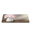A white vase with a smiley face holding pink flowers on a wooden shelf, with the words 'Thank you' written on the right. Produktbild-Vorschau