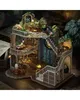A detailed miniature model of a magical house, possibly a DIY kit, with multiple levels, stairs, windows, and decorative elements like plants and potion bottles. Náhled obrázku produktu