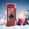 A festive Christmas scene with a red telephone booth lantern, a lit candle, and pine branches. Náhled obrázku produktu
