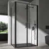 A modern bathroom with a black framed glass shower enclosure. Voir les images du produit