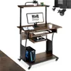 A computer desk with a monitor, keyboard, computer tower, and gaming console. Produktbild-Vorschau