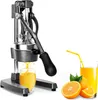 A manual citrus juicer with a glass of orange juice and oranges. Podgląd zdjęcia produktu
