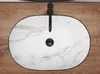 A top-down view of a marble-patterned sink with a black faucet and drain. Náhľad obrázku produktu