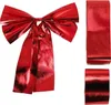 A red metallic bow and two rolls of red metallic ribbon on a white background. Náhled obrázku produktu