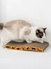 A cat is on a scratching pad. Produktbild-Vorschau