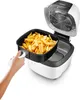 A hand is shown removing a basket full of french fries from an open air fryer. Anteprima dell’immagine prodotto